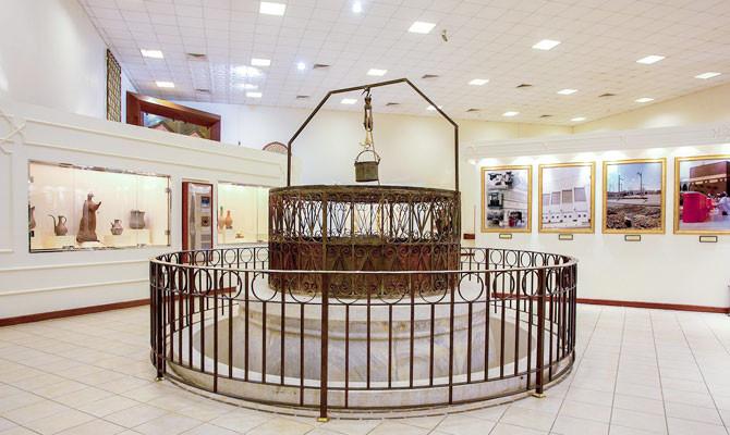 A museum display of historic well equipment.